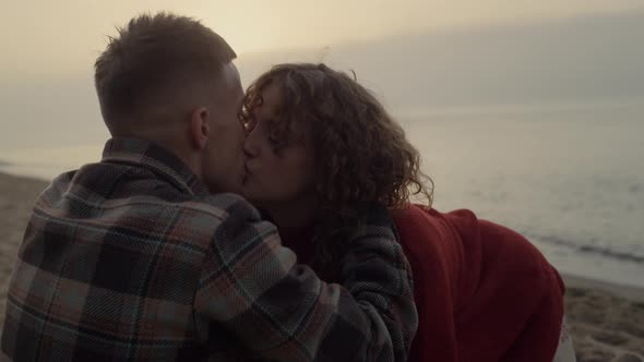 Romantic Couple Kissing on Beach at Sunrise