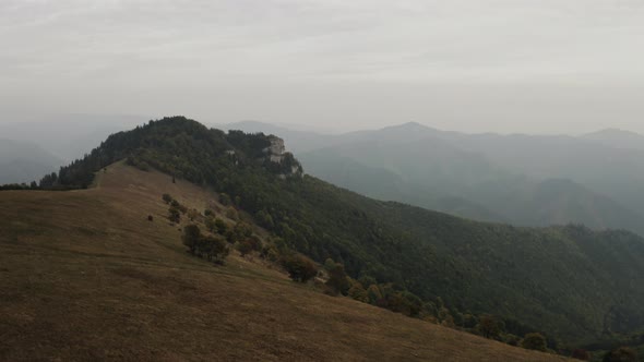 Fast flying towards rock formation over autumn trees, Aerial wide shot, Slovakia