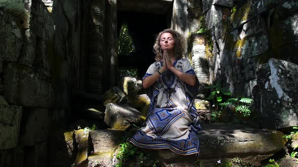 Yoga Woman In Ethnic Dress With Hands In Namaste In Ancient Temple