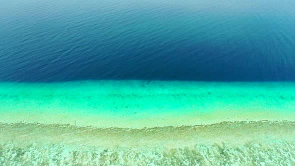 Aerial top down nature of tranquil coast beach trip by blue green sea with white sand background of 
