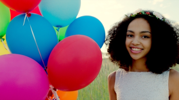 Young Girl With Colour Balloons In Sunset