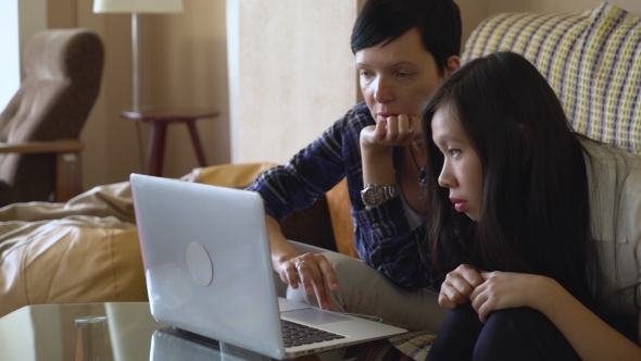 Two Women Working Together With Laptop At Home.