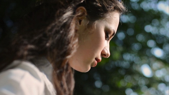 Happy Teen Girl Playing on Guitar Outdoor at Sunset