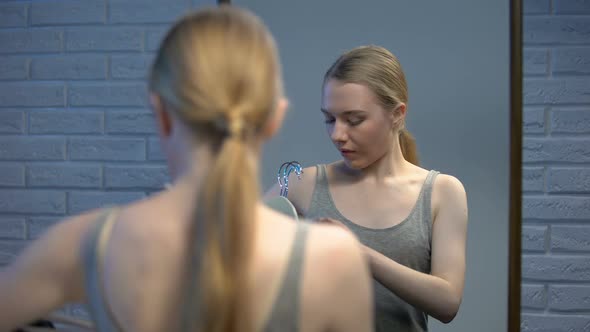 Young Woman Choosing Dress for Party Front of Mirror Smiling on Camera, Style