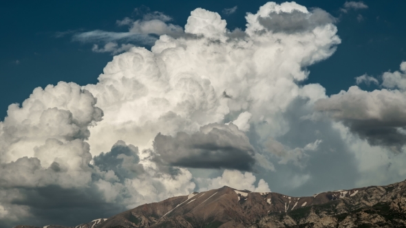   Of Large Clouds Moving Over Mountain