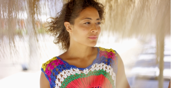 Serious Woman Under Thatch Beach Umbrella