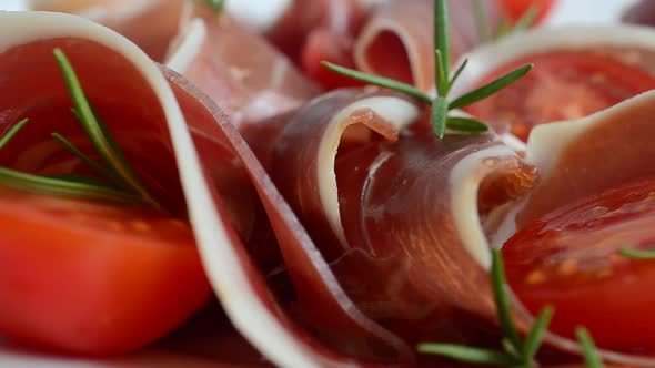 Jamon with tomatoes and rosemary.