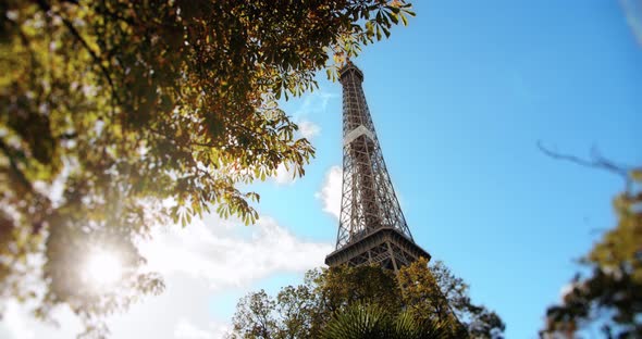 Eiffel Tower in Paris Through the Leaves of Trees in Sunlight, Autumn
