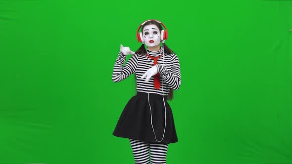 Mime Woman Listening To the Music Through Headphones