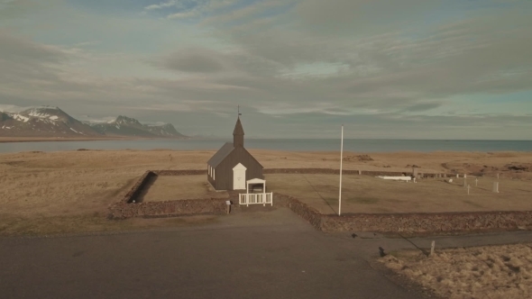 Black Wooden Church And Small Cemetery