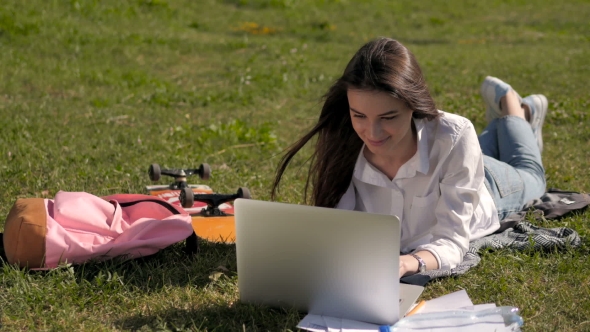 Student Girl Working With Laptop In Park Of a University Campus