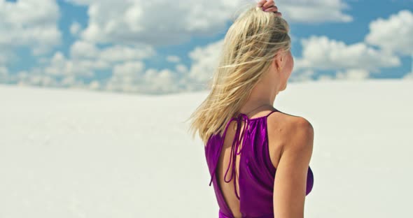 Cinematic Slow Motion of a Woman Walking on a Sand Dune