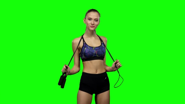 Woman Holding Jump Rope On Her Shoulders. Green Screen