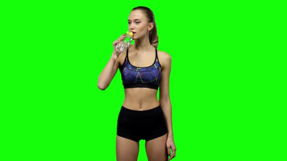 Woman In Sportswear Drinking Water From Bottle. Green Screen