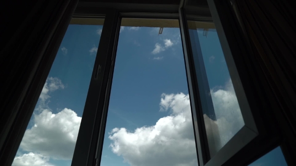 Flight Of The Camera Through An Open Window Into The Blue Sky With Clouds