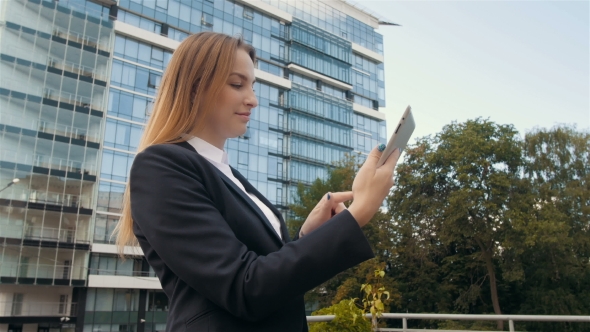Portrait Of Beautiful Business Woman Using Tablet PC Outside Business Center