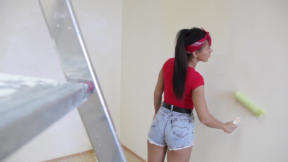 Girl Paints a Wall Roller White.