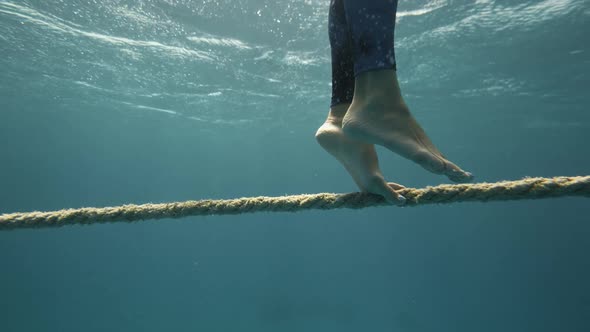 Beautiful Woman in Flowing Dress Walk Rope Underwater Dark Background She Swims to Surface of Water