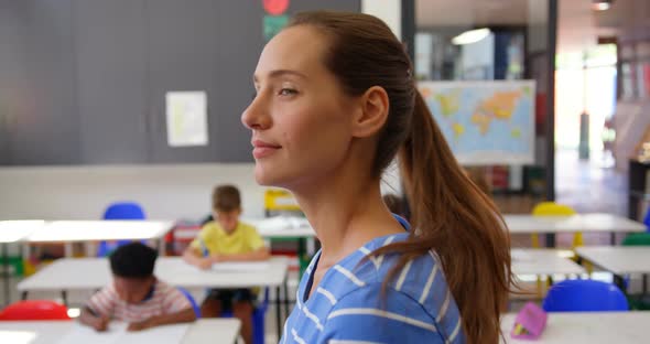 Side view of Caucasian female teacher smiling in the classroom 4k