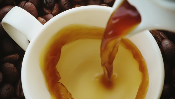 Coffee Being Poured Into Coffee Cup