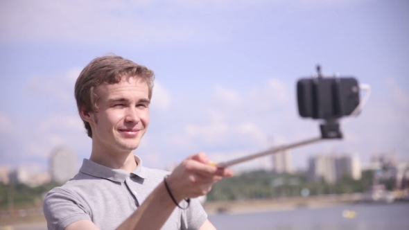 Man Takes Selfie in City, Urban Landscape