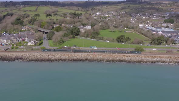 Commuter Train Travelling Slowly Alongside the Sea