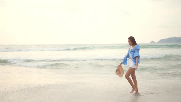 Asian woman enjoy around beautiful beach sea ocean