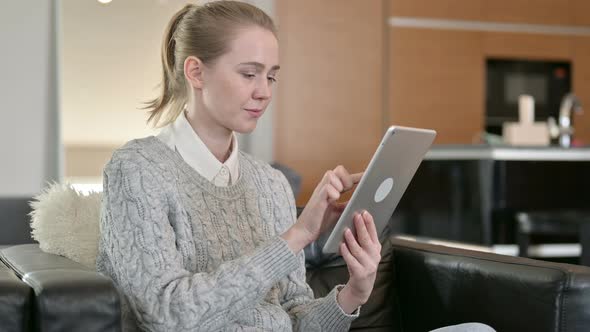 Smiling Young Woman Using Tablet at Home 