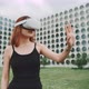 A woman using augmented reality goggles in the city - VideoHive Item for Sale
