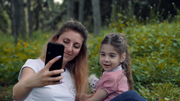 Mother With Child Looking Cartoon. Family Make Video Call To Daddy. Happy Family.