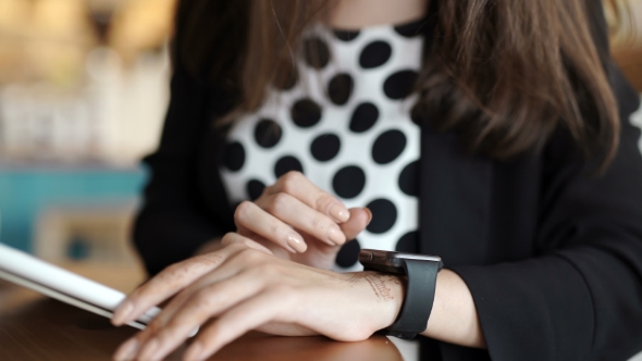 Woman With Smart Watch Working On Tablet