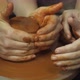 A Potter Shows How To Properly Hold a Piece of Clay on a Potter's Wheel - VideoHive Item for Sale