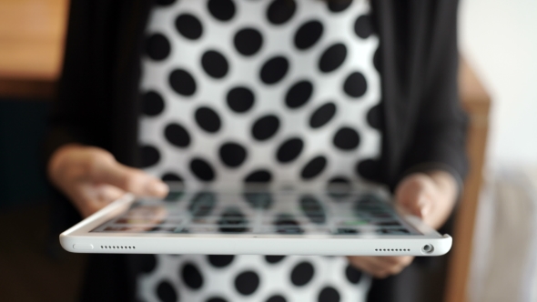 Smiling Young Woman Using a Digital Tablet Hands 