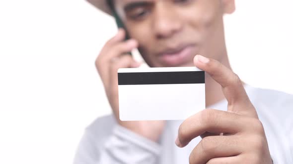 Close Up of Person Hand Holding Credit Card Talking on Smart Phone