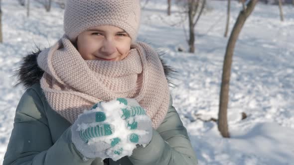 Child game with a snowball.