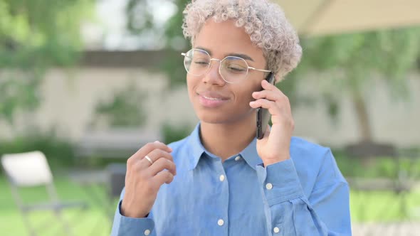 Portrait of Happy Young African Woman Talking on Phone