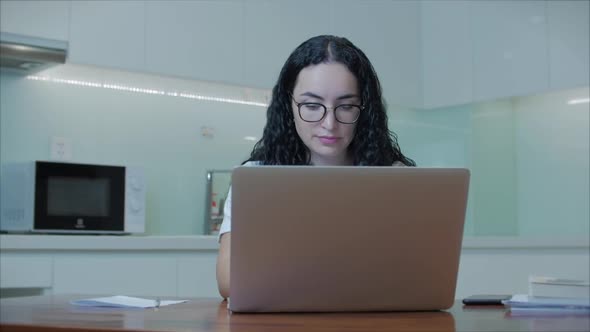 Woman Typing on Laptop Sitting on Sofa at Home, Businesswoman Sits at Home Types on Smartphone