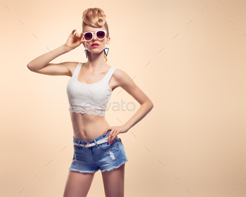 style. Fashion Makeup. Blond sexy Model, Trendy Glamour fashion Sunglasses. Playful cheeky fashion girl. Unusual Creative.Party disco mohawk hairstyle