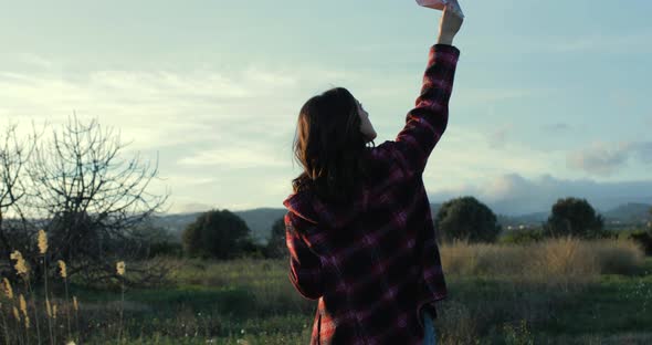 Girl plays with paper plane