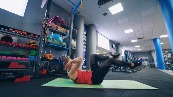 Woman exercising on yoga mat. Young beautiful girl wearing fashion sports wear doing exercise on mat