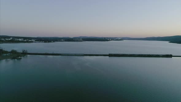 Aerial of Train Passing on Tracks Over the Hudson River at Sunset