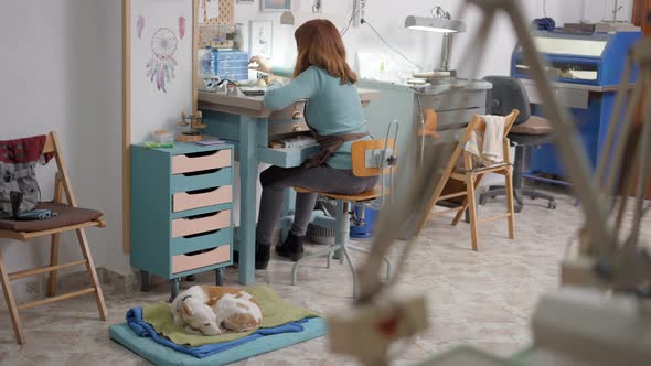 Female Artisan Making Jewel For Pet Is Busy On Her Small Working Place