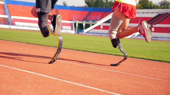 Slow Motion of Two Sportsmen with Prosthetic Legs Running