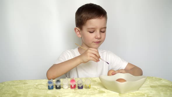 A Boy Paints Easter Eggs and Prepares to Celebrate Easter