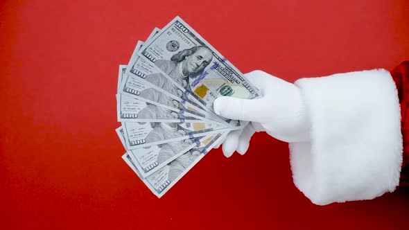 Santa Claus Hand Throw Money Into Air Red Background