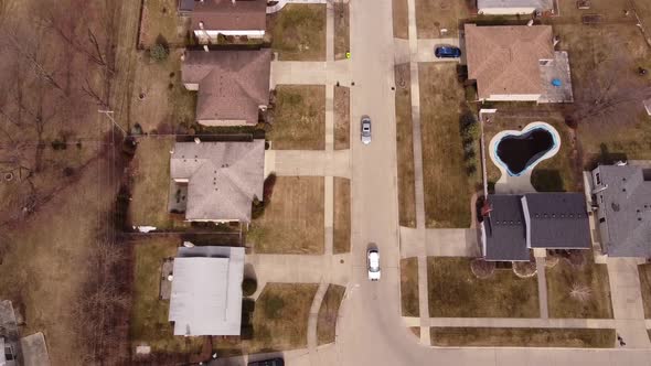 Vehicles Driving Through The Road Of Suburban Homes In Sterling Heights, Macomb County, Michigan, Un