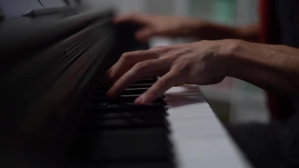 Closeup Hands of Unrecognizable Musician Man Playing on Synthesize at Home Studio