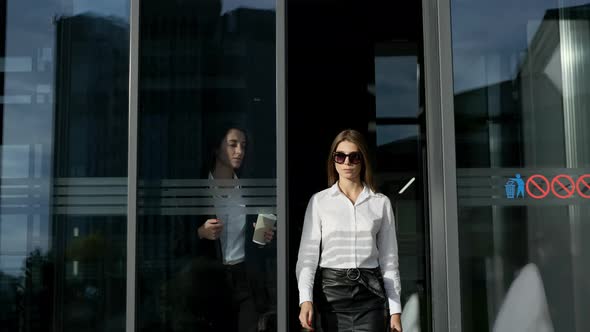 Two Businesswomen Leave The Office.