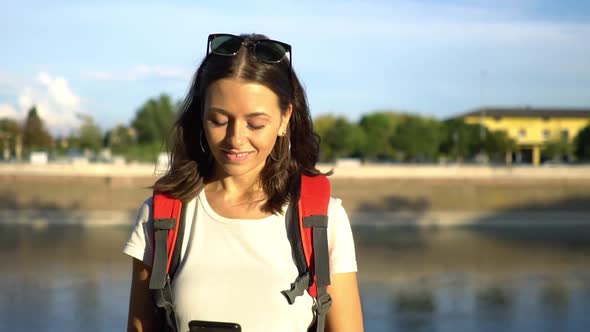 Portrait of female tourist with mobile phone