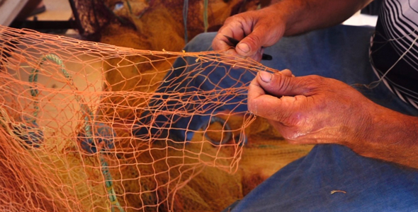 Fisherman Repairs Fishnets 1